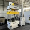 100 ton four column hydraulic press left side view showing rigid welded frame and hydraulic cylinder structure